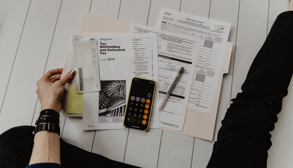 Accountant working with calculator and financial documents - representing the Hayward CPA practice that hit #1 in 136 days